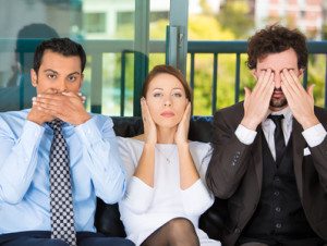 Businesspeople imitating see, hear, speak no evil concept