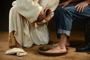 Jesus Washing Feet of Man in Jeans