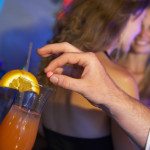 Man Drugging Woman's Drink In Bar