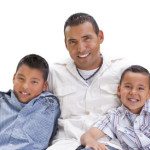 Handsome Hispanic Father and Sons Isolated on a White Background.