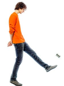 one young man caucasian kicking tin can sad bore side view in studio white background