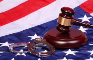 Judge Gavel and Handcuffs over American Flag